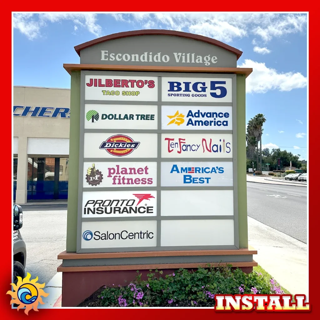 large marquee sign listing multiple stores in a commercial shopping center